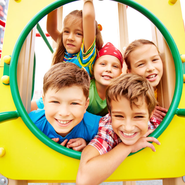 Image of joyful friends having fun on playground outdoors